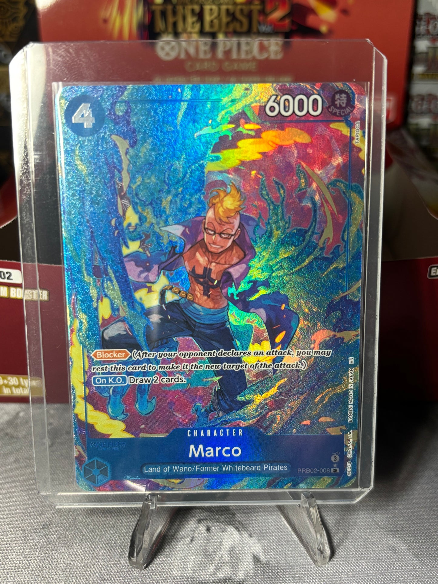 Colorful trading card featuring a character named Marco on a reflective surface.