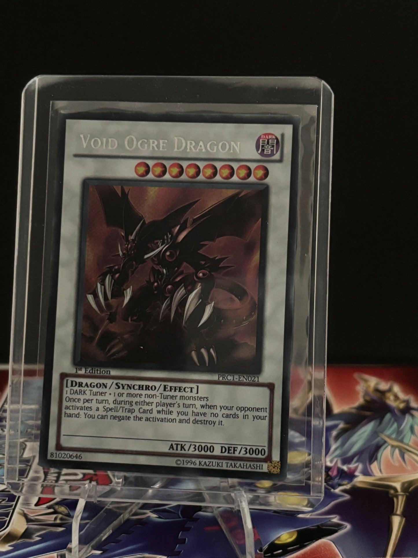 Trading card featuring a void ogre dragon in a clear protective case.