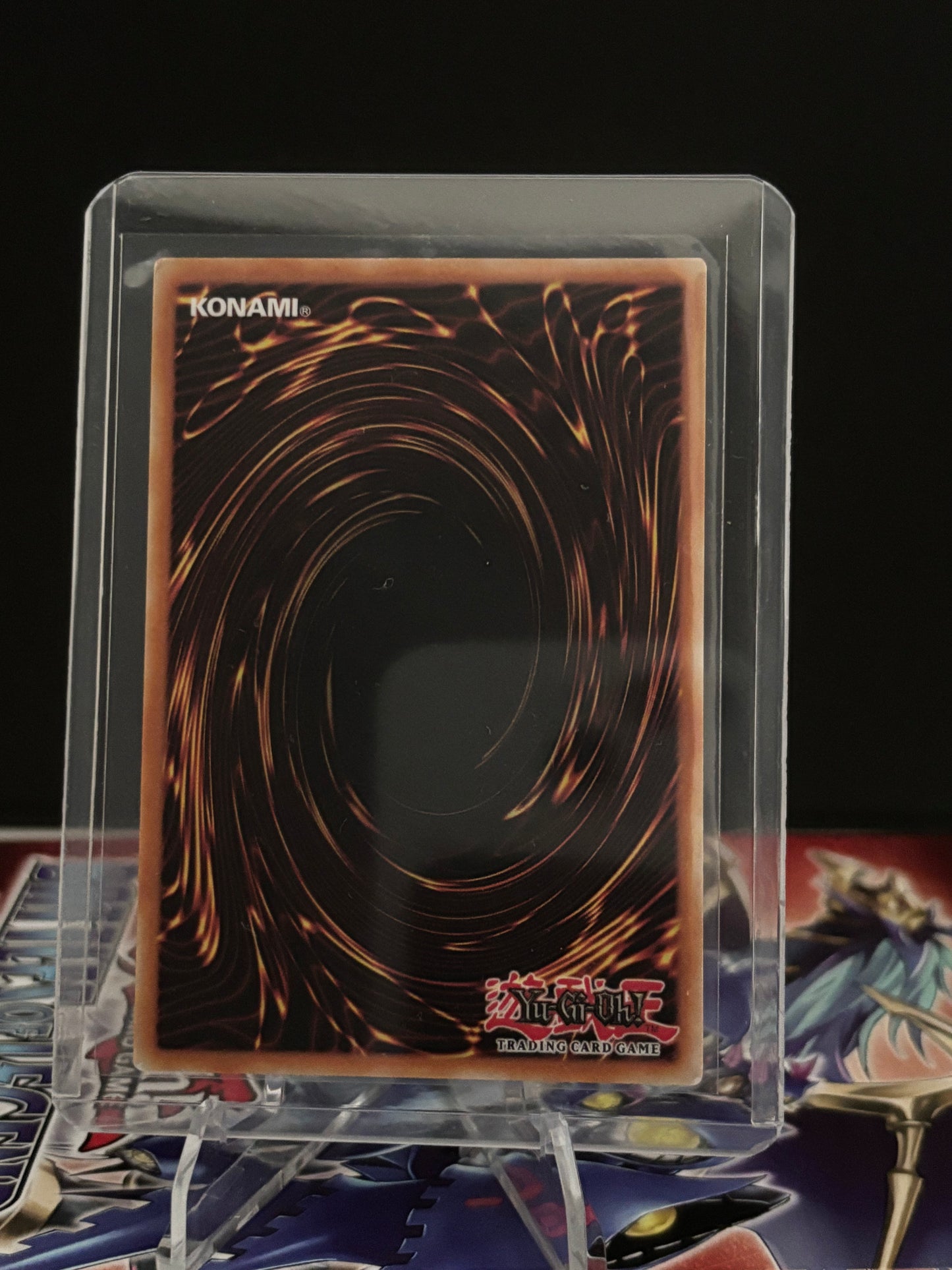 Trading card in a clear protective case on a dark background